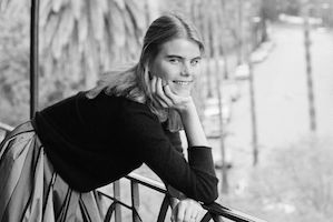 Black and white image of younger Mariel on a balcony